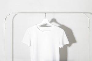 white t shirt hanging on a rack