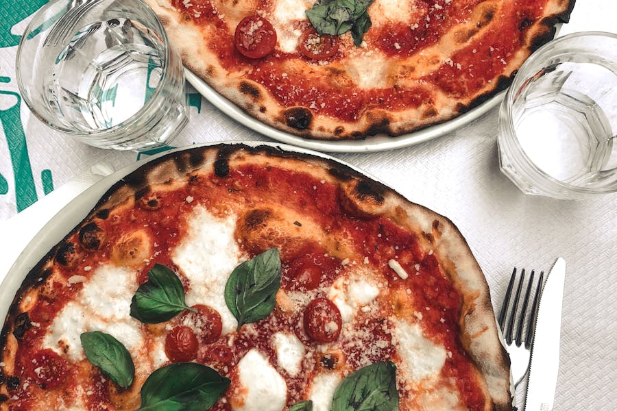 Two delicious pizzas topped with mozzarella and basil, perfect for a tasty meal.